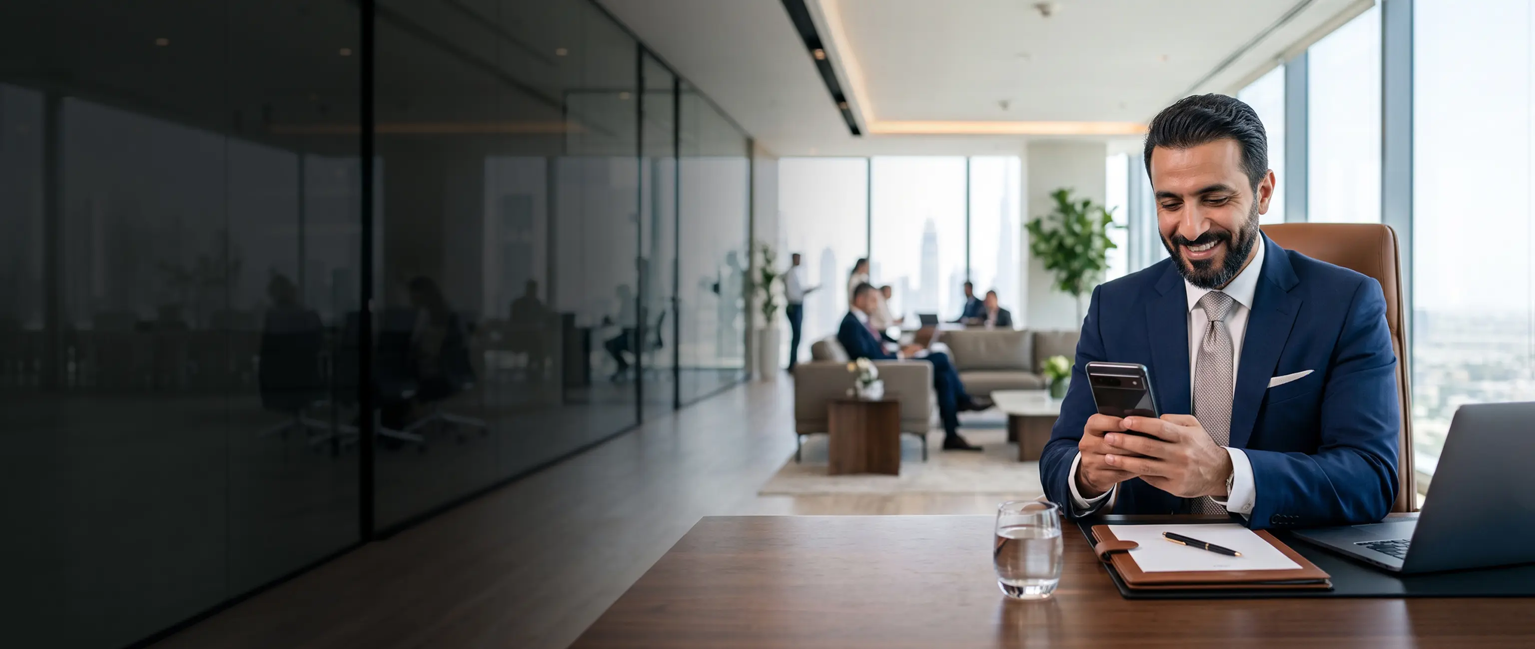 A smiling professional seamlessly managing his investments using National Bonds digital channels on a smartphone.
