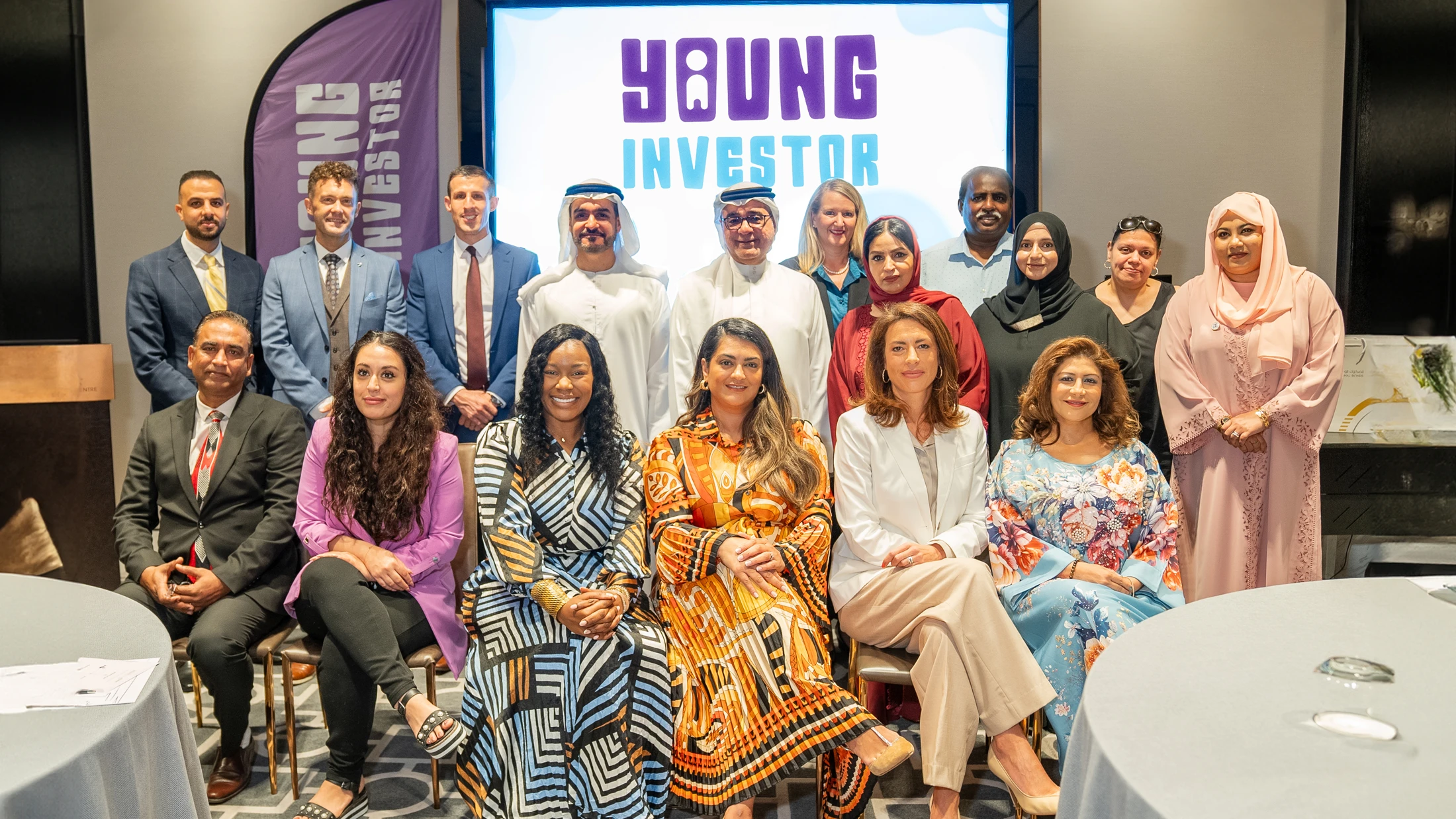 A group photo of National Bonds and Knowledge Fund Establishment representatives alongside school officials, celebrating the addition of new schools to the Young Investor program.