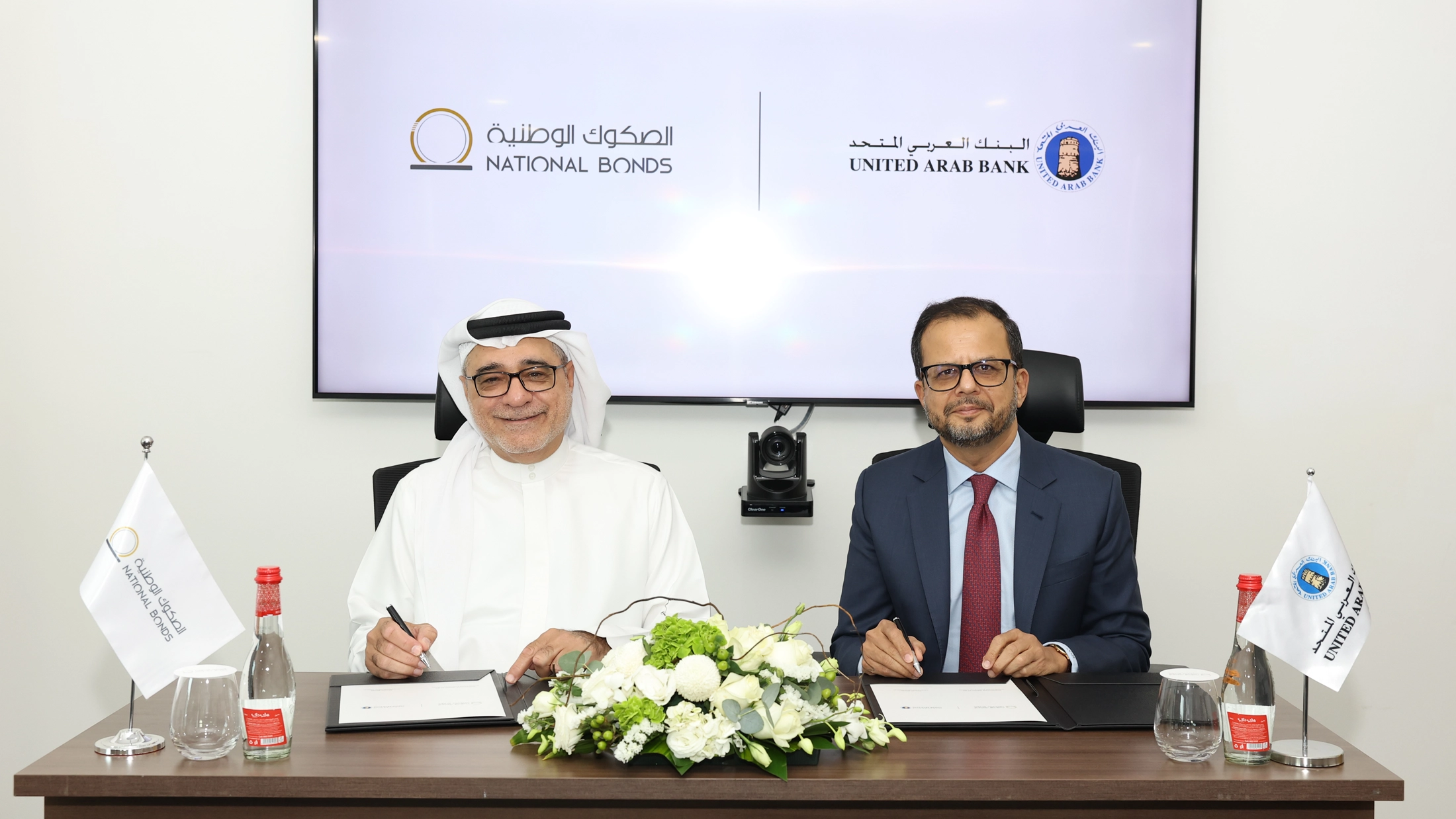 Mohammed Qasim Al Ali, Group CEO of National Bonds, and Shirish Bhide, CEO of United Arab Bank, signing an agreement to onboard UAB to the Sharia-compliant Al Manassah platform.