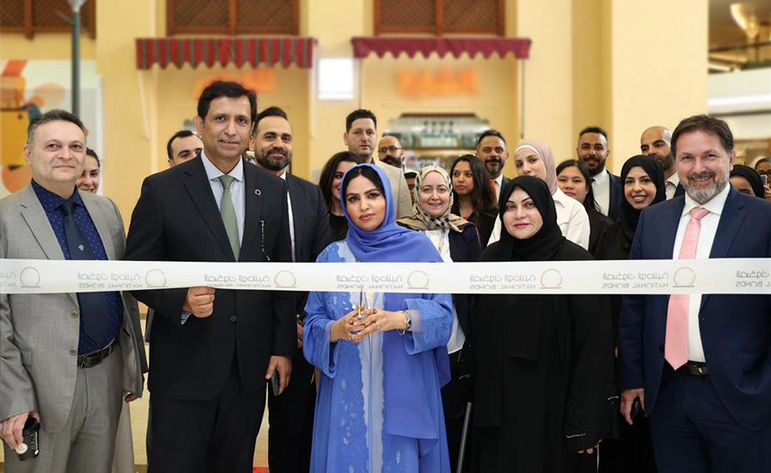 Rehab Lootah, Deputy Group CEO of National Bonds, alongside other officials, cutting the ribbon at the grand opening of the new National Bonds branch in Al Ain Mall.